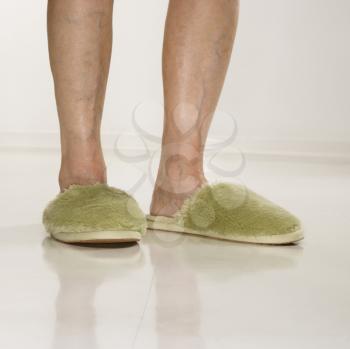 Royalty Free Photo of an Older Woman Wearing Green Slippers