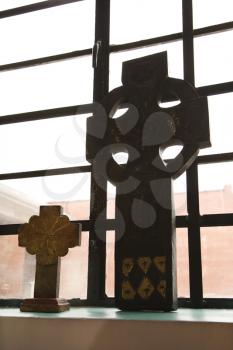 Royalty Free Photo of Celtic Crosses Sitting on a Windowsill