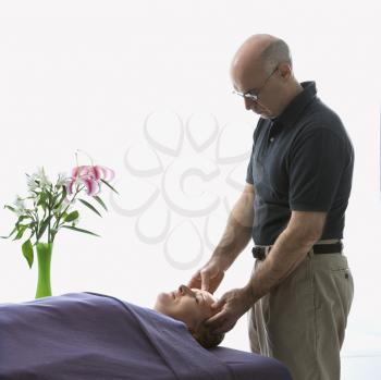 Royalty Free Photo of a Massage Therapist Massaging a Woman Lying on a Massage Table