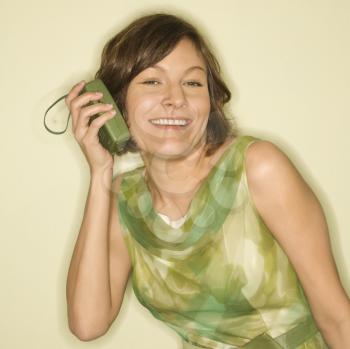 Royalty Free Photo of a Woman Wearing a Vintage Dress With a Handheld Radio Smiling