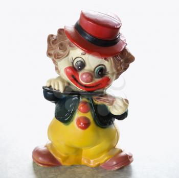 Royalty Free Photo of a Vintage Smiling Clown Figurine Playing the Violin 