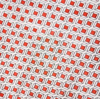 Close-up of vintage fabric with repetitive red cube designs printed on polyester.