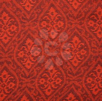 Royalty Free Photo of a Red Textural Vintage Fabric With Repetitive Shapes and Designs