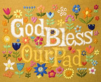Royalty Free Photo of a Vintage Needlepoint Wall Hanging of Colorful Flowers Surrounding the Phrase God Bless Our Pad