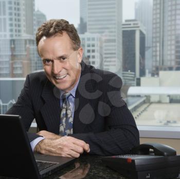 Royalty Free Photo of a Businessman Sitting in His Office