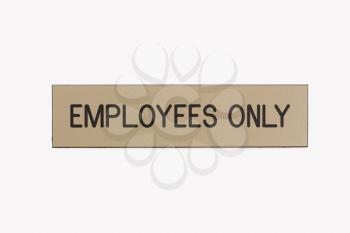 Employees only sign on white background.