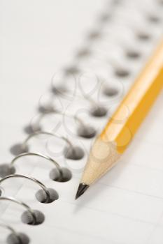 Royalty Free Photo of a Close-up of a Pencil on Top of a Spiral Bound Notebook