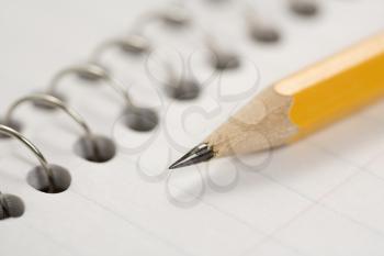 Royalty Free Photo of a Pencil on Top of a Spiral Bound Notebook