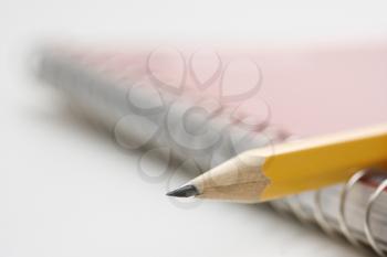 Royalty Free Photo of a Sharp Pencil Placed on a Spiral Bound Notebook