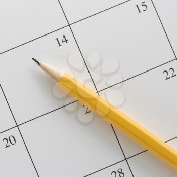 Royalty Free Photo of a Pencil on Top of a Blank Calendar