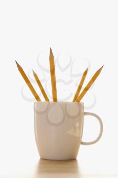 Royalty Free Photo of Five Pencils in a Coffee Cup With Pointed Ends Up