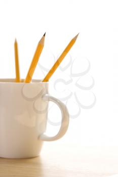 Royalty Free Photo of Pencils in a Coffee Mug With Pointed Ends Up