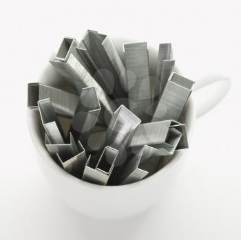 Royalty Free Photo of Many Staples Arranged in a Coffee Cup