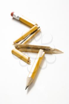Royalty Free Photo of a Pencil Broken in Several Places