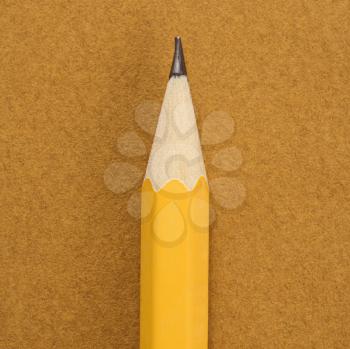 Royalty Free Photo of a Close-up of a Sharp Pencil Tip on a Tan Background