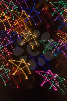 Royalty Free Photo of Multicolored Lights Forming an Abstract Star Pattern from a Motion Blur