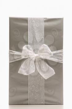 Royalty Free Photo of a Still Life of a Large Silver Wrapped Christmas Gift With a Bow