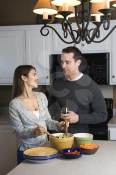 Royalty Free Photo of a Couple Making Salad at a Kitchen Counter
