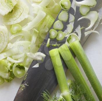 Royalty Free Photo of a Close up of chopped fennel with large kitchen knife