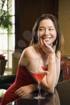 Royalty Free Photo of a Woman Sitting at a Bar With a Martini 