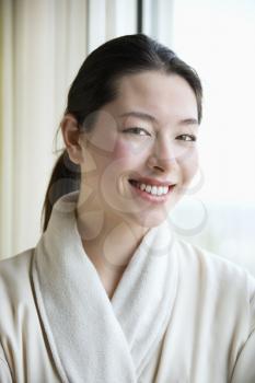 Royalty Free Photo of a Woman in a Bathrobe Smiling