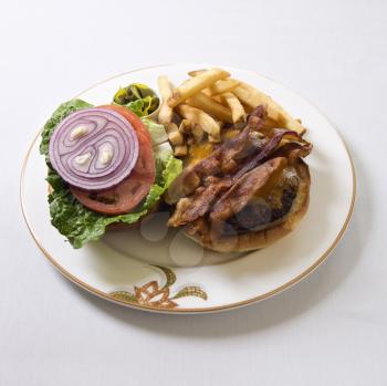 Royalty Free Photo of a Cheeseburger and French Fries on a Plate