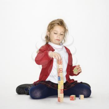 Royalty Free Photo of a Girl Playing With Toy Blocks