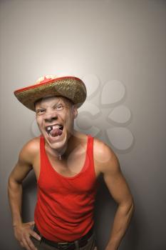 Royalty Free Photo of a Man Wearing a Straw Hat With a Funny Expression