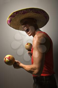Royalty Free Photo of a Man Wearing a Sombrero and Holding Maracas