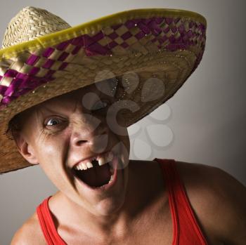Portrait of a mid-adult Caucasian male wearing sombrero with with funny expression.
