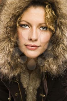 Royalty Free Photo of a Woman Wearing a Coat With a Fur Hood