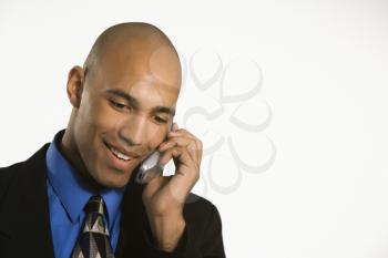 Royalty Free Photo of an African American Man in a Suit Talking on a Cellphone