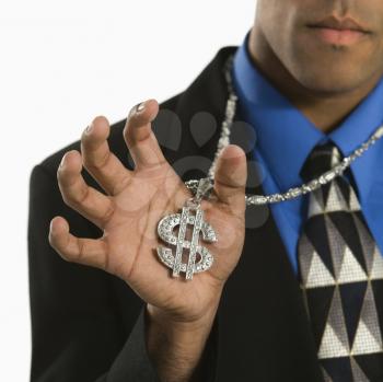 Royalty Free Photo of a Businessman Wearing a Chain Necklace With an Over Sized Dollar Sign
