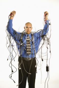 Royalty Free Photo of a Businessman Wrapped in  Computer Cables