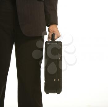 Royalty Free Photo of an African American Businessman in a Suit Holding a Briefcase