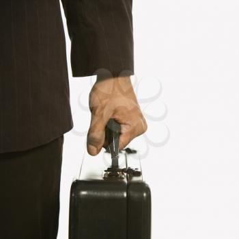 Royalty Free Photo of an African American Businessman in a Suit Holding a Briefcase