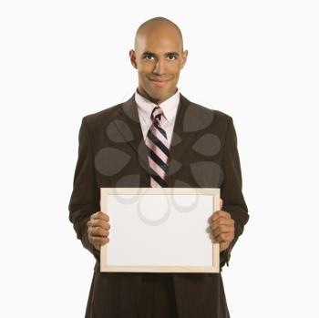 Royalty Free Photo of a Man Holding a Blank Sign Against a White Background