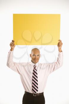 Royalty Free Photo of a Man Holding Up a Blank Sign 