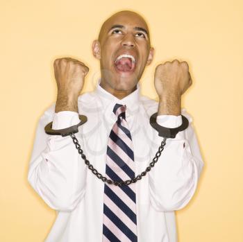 Royalty Free Photo of a Man Wearing Handcuffs and Screaming