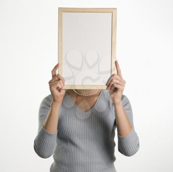 Royalty Free Photo of a Businesswoman Holding Up a Blank Dry Erase Board in Front of Her Face