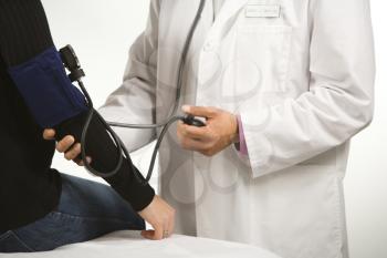 Royalty Free Photo of a Male Doctor Testing Blood Pressure of a Woman