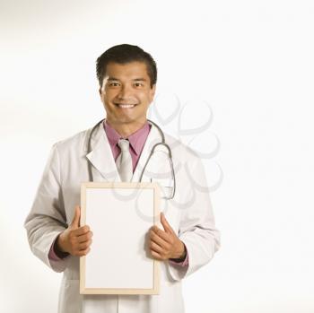 Royalty Free Photo of a Male doctor holding blank sign