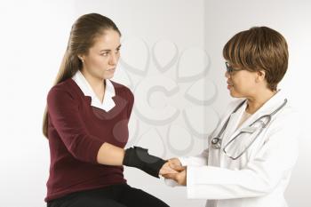 Royalty Free Photo of a Doctor Examining the Wrist of a Patient