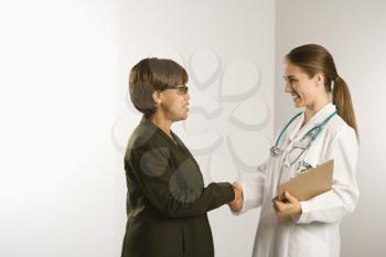 Royalty Free Photo of a Doctor Shaking Hands With a Female Patient