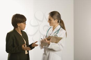 Royalty Free Photo of a Female Doctor Talking with a Female Patient
