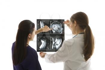 Royalty Free Photo of Female Doctors Analyzing an X-ray