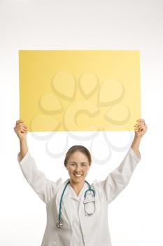 Royalty Free Photo of a Doctor Holding Up a Blank Sign
