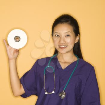 Royalty Free Photo of a Doctor Holding a Compact Disc
