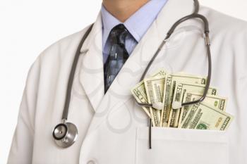 Royalty Free Photo of a Physician With Cash Hanging Out of His Pocket