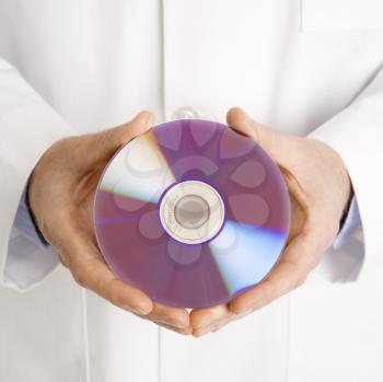 Royalty Free Photo of a Man in Holding a Compact Disc